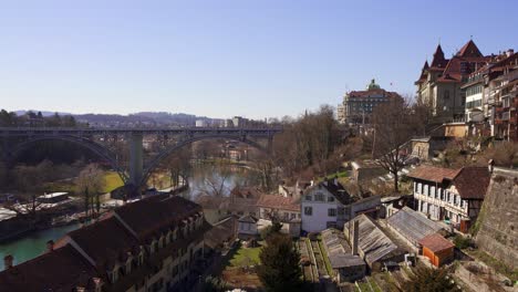 panning view of an iron bridge crossing the river aare in bern, the historic capital city of switzerland