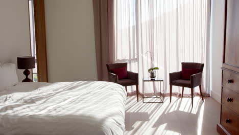 sunlight filtering through sheer curtains, in modern clean bedroom at home