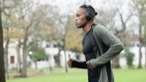 training, running and music with black man in park