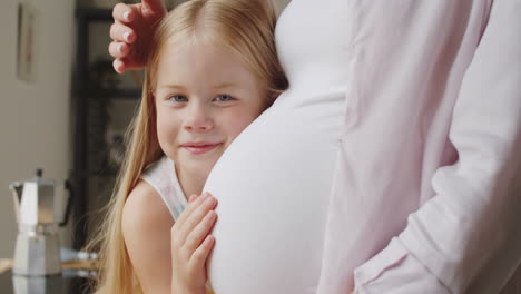 little girl and pregnant mom