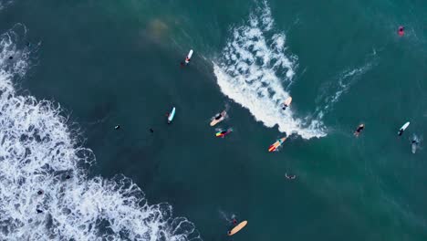 surfer caught the wave, while others are waiting and chilling