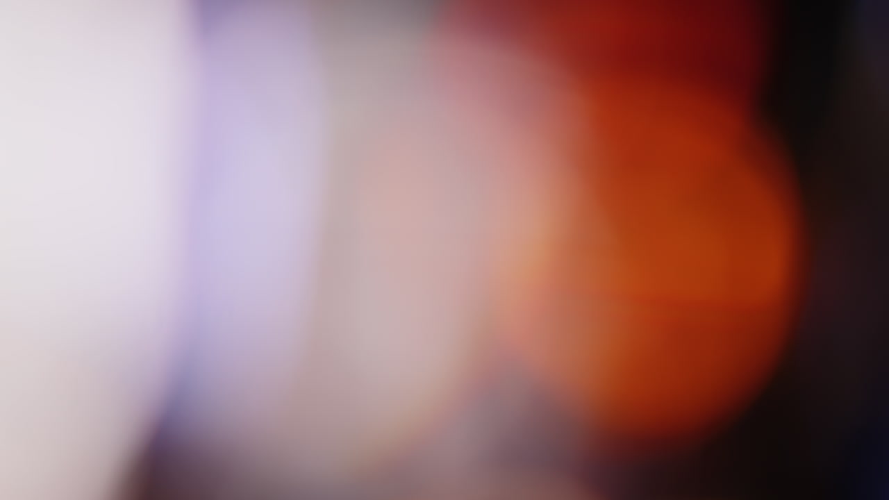 Multicolored light leaks 4k footage on black background stylizing video transitions bokeh effect