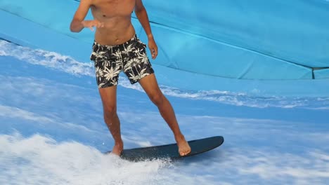 person surfing in an artificial wave pool