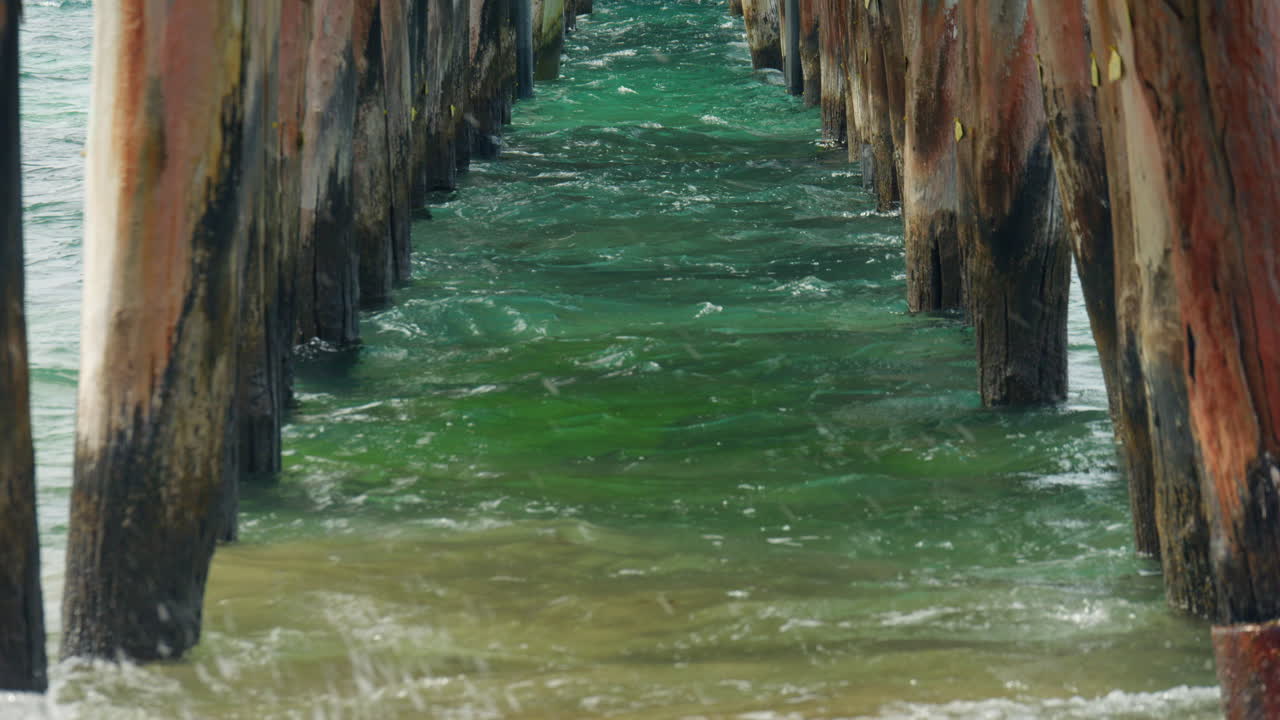 vista inclinada en cámara lenta bajo el viejo muelle de madera