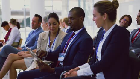 business people discussing over digital tablet in a seminar 4k