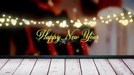 Animation-of-fairy-lights-and-happy-new-year-text-over-wooden-boards