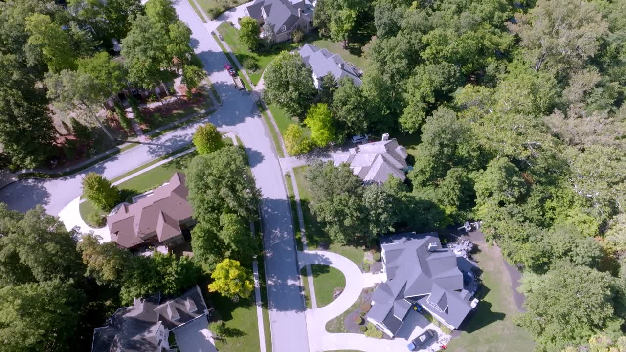 Neighborhood homes in Carmel, Indiana with drone video tilting up