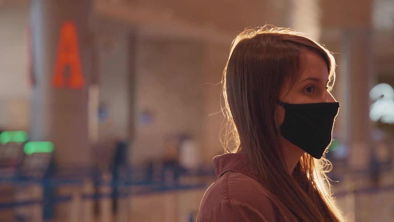 A woman in mask at the airport