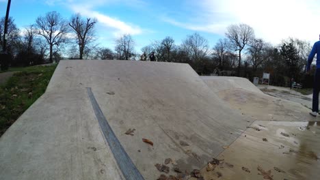 Close-up-of-a-skateboarder-trying-a-one-hundread-eighty-ollie-trick-on-top-of-a-bank-,-the-skater-is-seen-up-to-the-shoulders