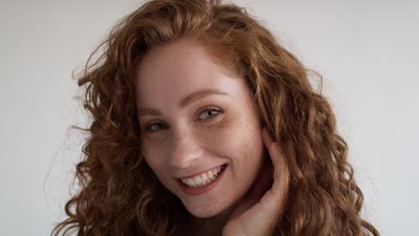 Close-up-portrait-of-laughing-young-caucasian-woman-on-white-background.