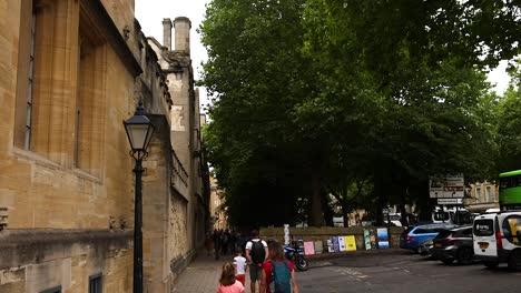 pedestrians walking along a historic street