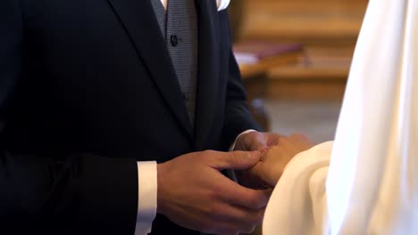 The-bride-and-groom-exchange-rings-during-the-wedding-ceremony