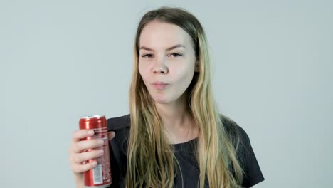 woman drinking soda from a can