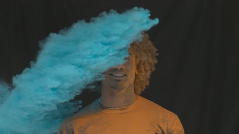 man in color powder explosion slow motion