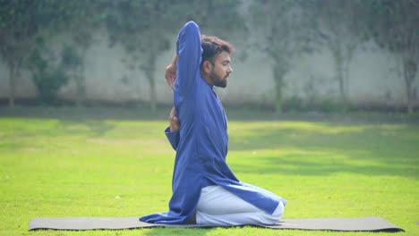 indian man doing cow face yoga pose