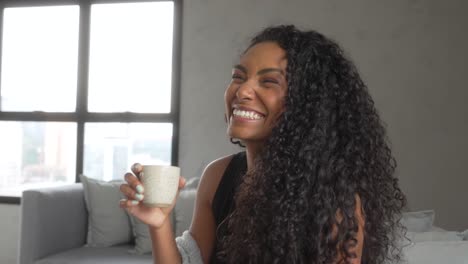 woman-drink-and-smile-on-a-sofa