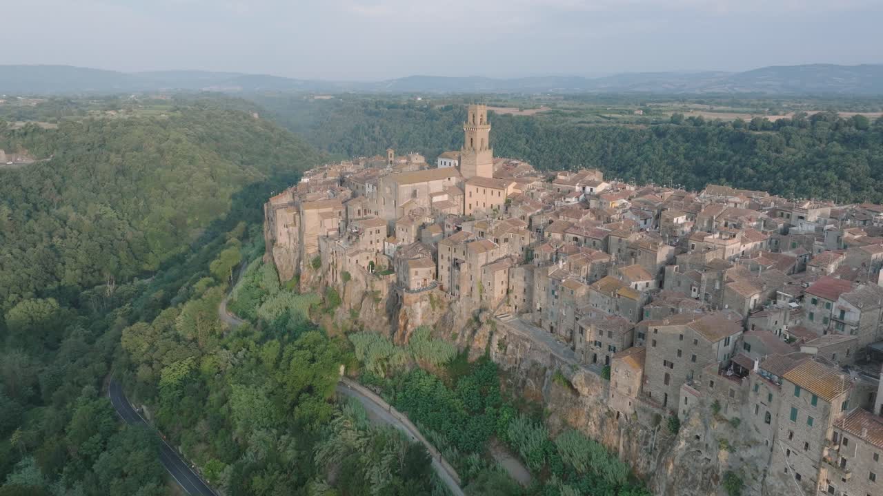 Aerial Drone view of the hilltop Medieval town of Pitigliano, Tuscany in morning light, with the Valdorcia and old buildings, in 4K