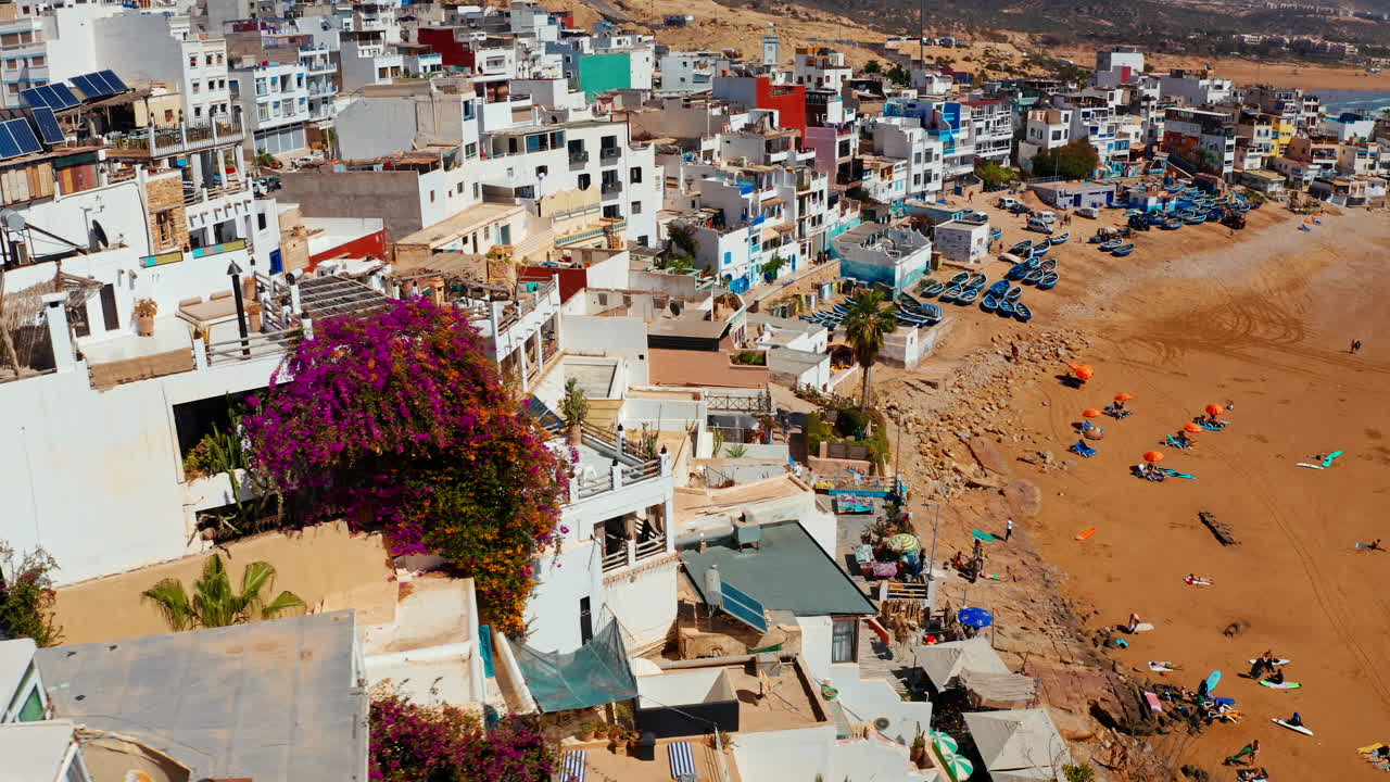 Aerial drone shot over the local beach town of Taghazout in Morocco.