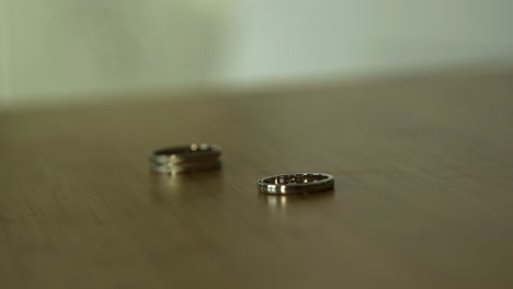 wedding rings on a wooden table