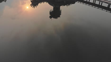 Big-dragon-at-Abandoned-Waterpark-Vietnam-during-sunrise,-aerial