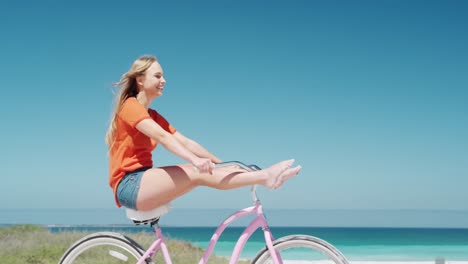 woman riding on her bike on the beach