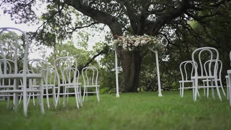 Garden-Wedding-With-Chairs-And-Decorated-Archway