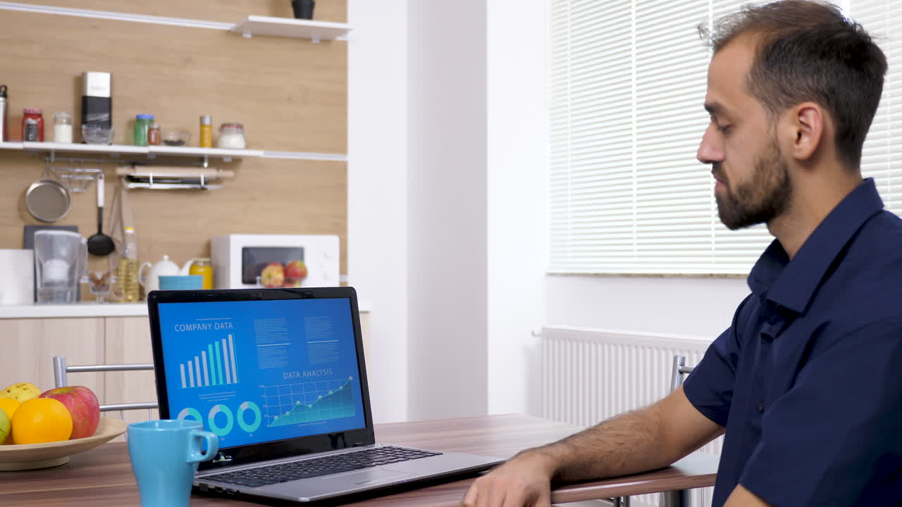 Man working on laptop in the kitchen