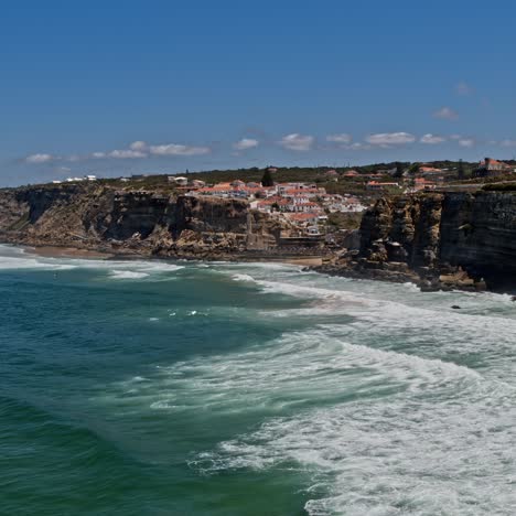 drone aerial view over long rocky coastline in portugal, on summer sunny day