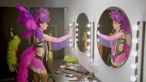 cabaret girl taking selfies and dancing in front of a mirror