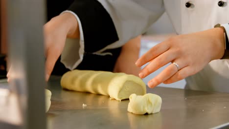 chef cutting dough in kitchen at restaurant 4k