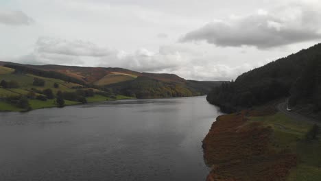 aerial footage over derwent reservoir, derbyshire, uk. derwent reservoir ends in the famous derwent dam, famed for being used as a practice ground by pilots for the dam busters raids during ww2