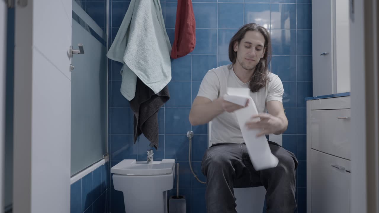 Man using the toilet in a bathroom