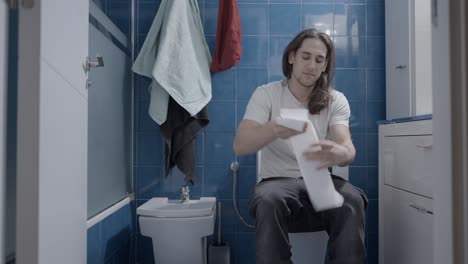man using the toilet in a bathroom