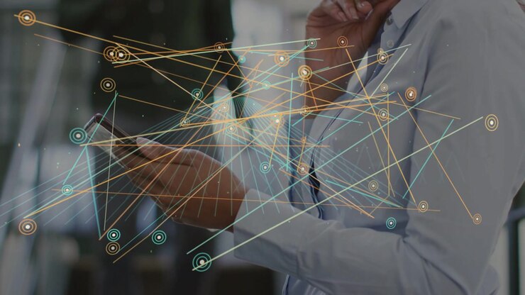 Woman tapping phone in office atrium, animating expanding network nodes and lines for data review