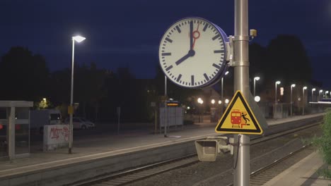 mechanical clock at the railway station displays 8 o'clock in the evening