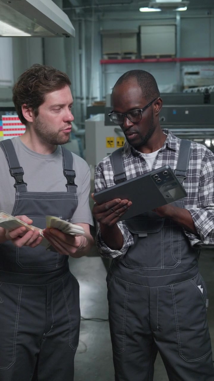 Printing Factory Technicians Checking Color Swatches and Using Tablet