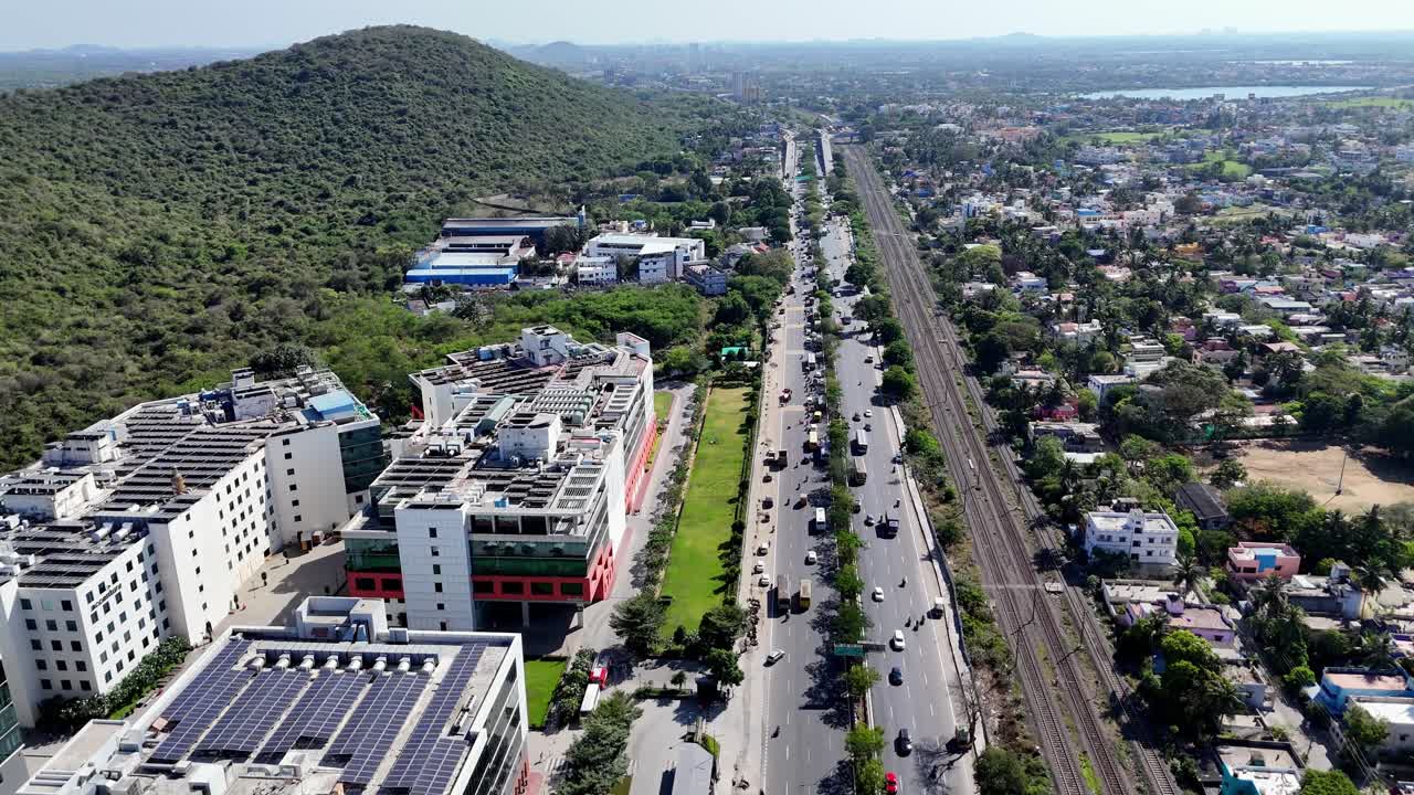 Under a cloudy sky, this breathtaking drone video eloquently captures the essence of urban life in Chennai, a residential neighbourhood and IT tech parks are equipped with solar panels. GST road