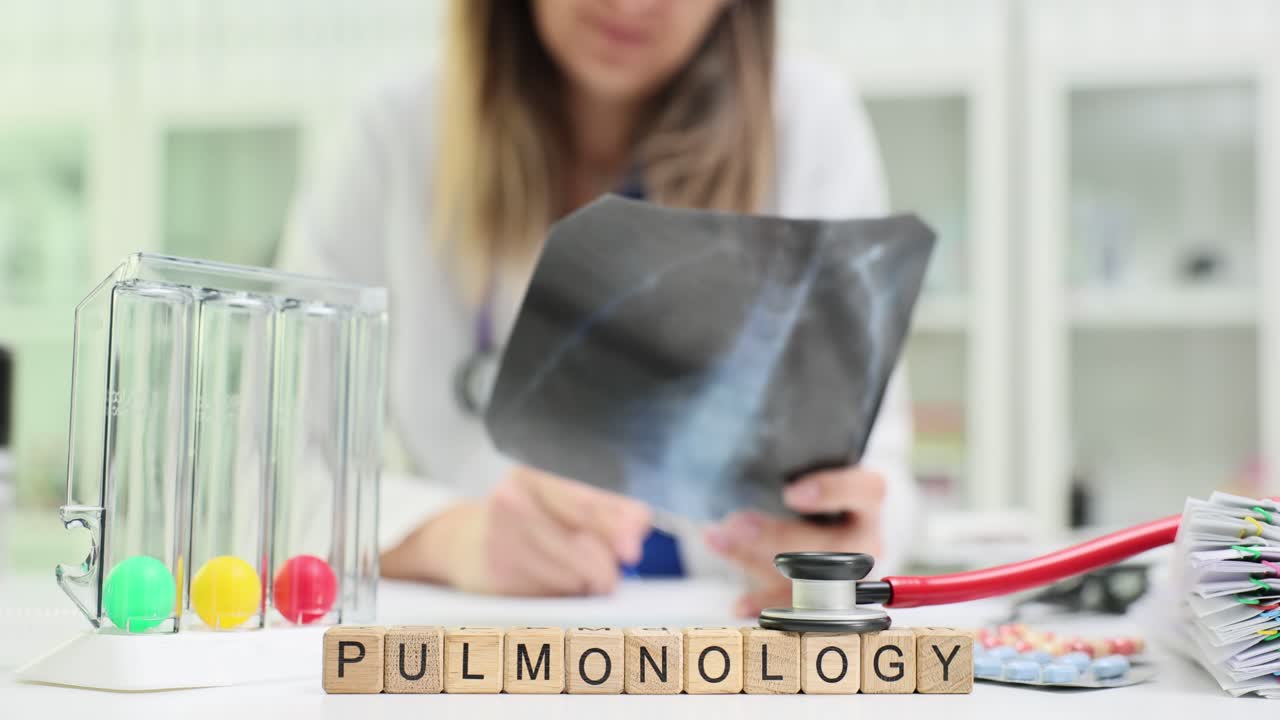 Medical professional examining an X-ray with 'Pulmonology' spelled out in the foreground