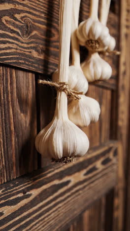 hanging garlic braids on a wooden wall