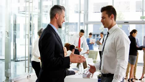 businessmen shaking hands in office