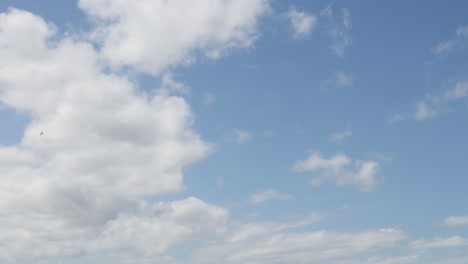 clouds drifting in a clear blue sky