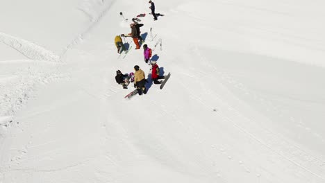 an exhilarating fpv drone shot capturing a snowboarder carving through deep powder snow on a bright winter day. the dynamic perspective highlights the snowboarder in the untouched snowy terrain