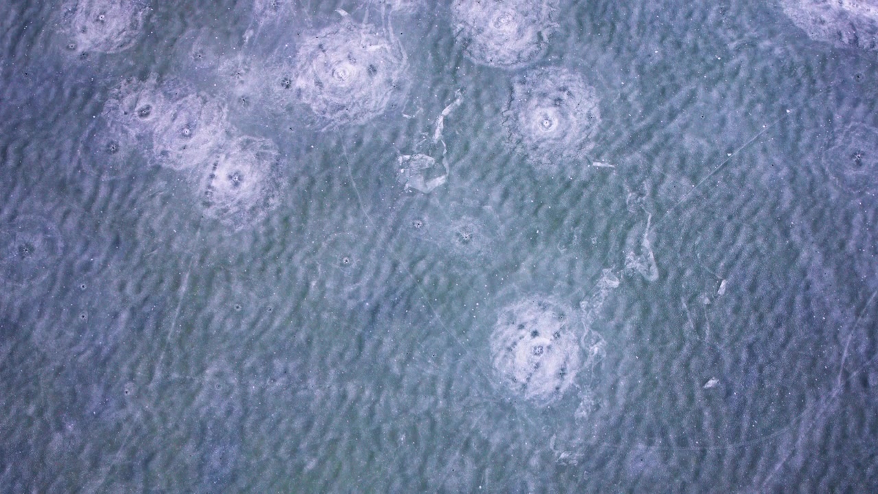 Cinematic aerial view of frozen freshwater ice in the Great Lakes during winter