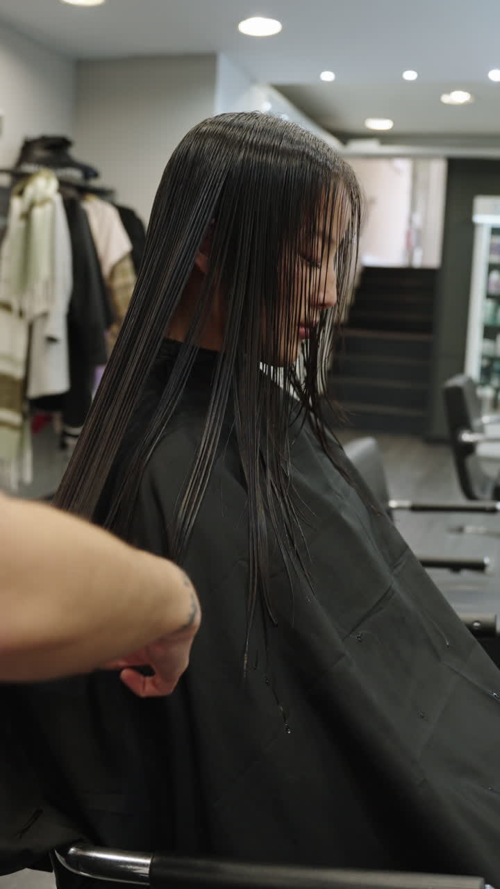Woman getting a haircut at a salon