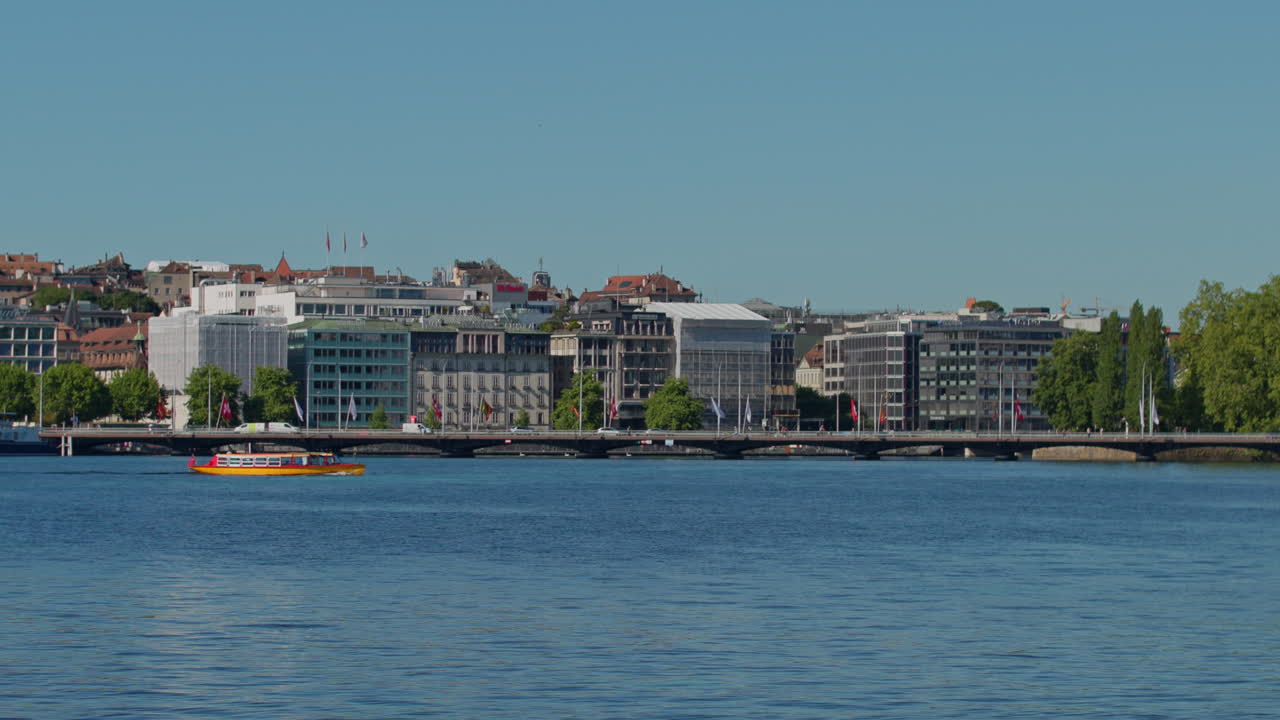 Peaceful morning in Geneva with the iconic Jet d’Eau rising from the lake, calm waters reflecting the clear sky, and the city slowly coming to life in the morning light.