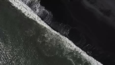 Aerial-Bird's-Eye-View-of-the-Black-Sand-Beach-With-Waves-Crashing-In-Iceland