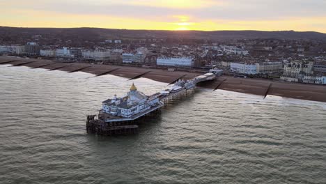 eastbourne pier and town at sunset sussex uk aerial pull back view 4k