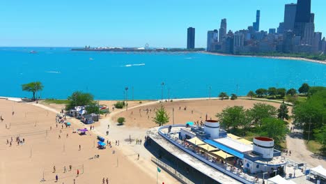 aerial flyby of north avenue beach in chicago illinois | downtown chicago in background | afternoon lighting