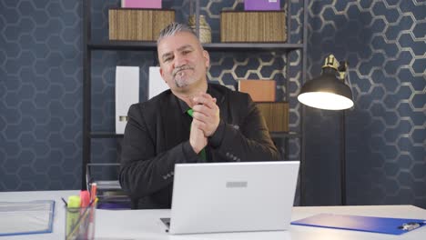 Businessman-clapping-while-looking-at-camera-with-pride-and-joy.