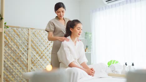 woman receiving a relaxing shoulder massage at a spa